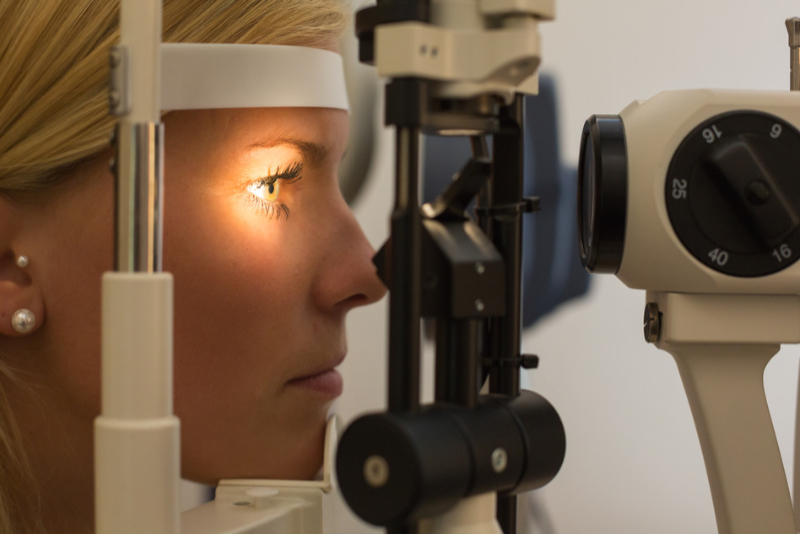 Patient at slit lamp of optician or optometrist